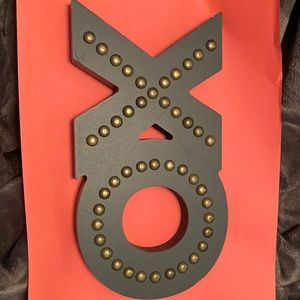 Studded Xo sign- dents and imperfections needs touch ups